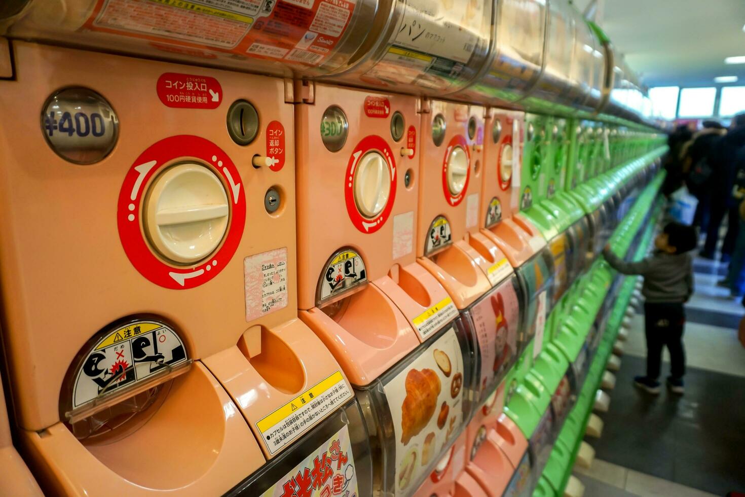 Osaka, Japan, January 14 2019 - Colorful and perspective view lots of Gachapon vending machine. Gachapon is the one of vending machine dispensed capsule toys popular in Japan. photo
