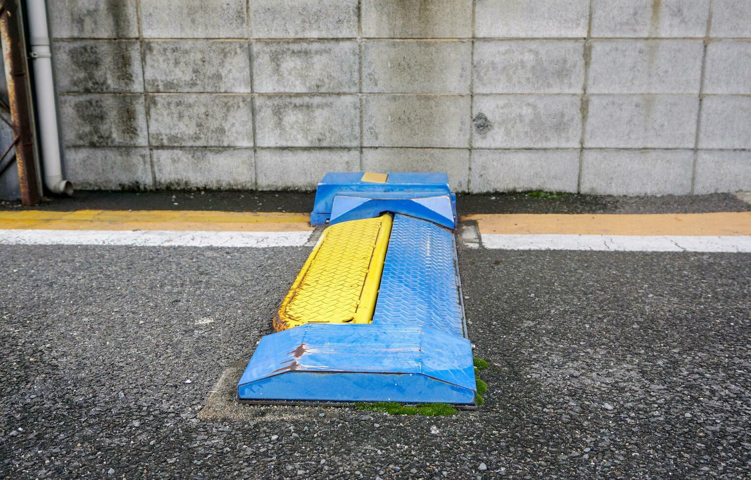 The metal plate under the car for to lock the wheels and car so that the car cannot be removed. Car lock device in paid parking lot. photo