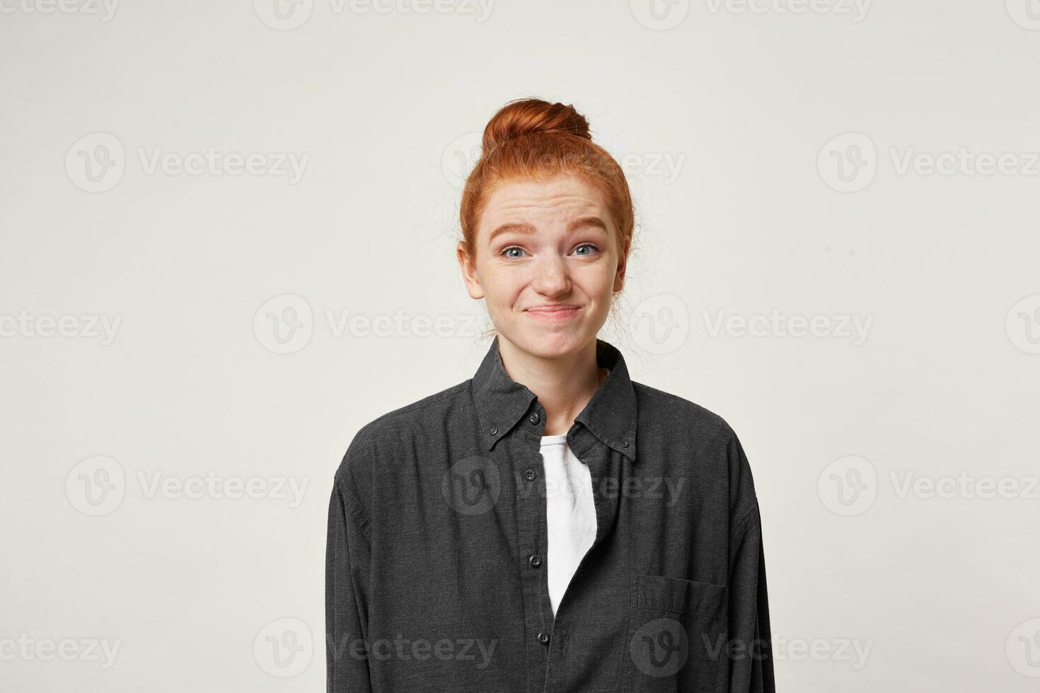 Guilty and confused young red-hair girl, having Oops expression on her face. Feeling sorry for doing something wrong,over white background photo