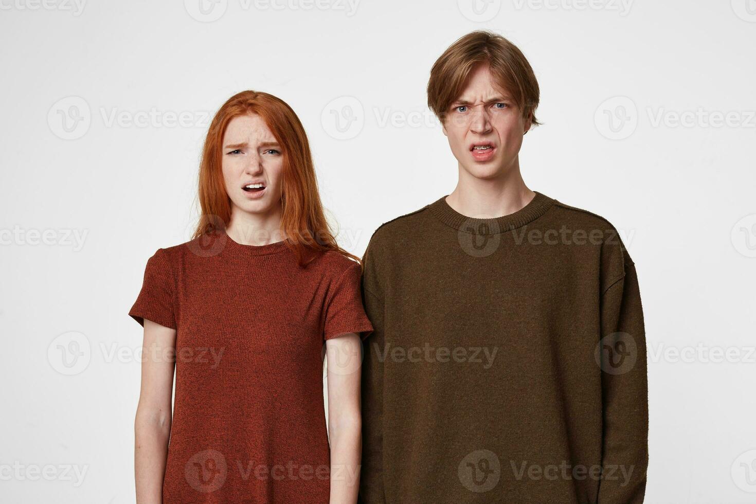 A disgruntled young guys wrinkled faces, make a grimace of disgust, expresses discontent, irritation. People and negative facial expressions photo