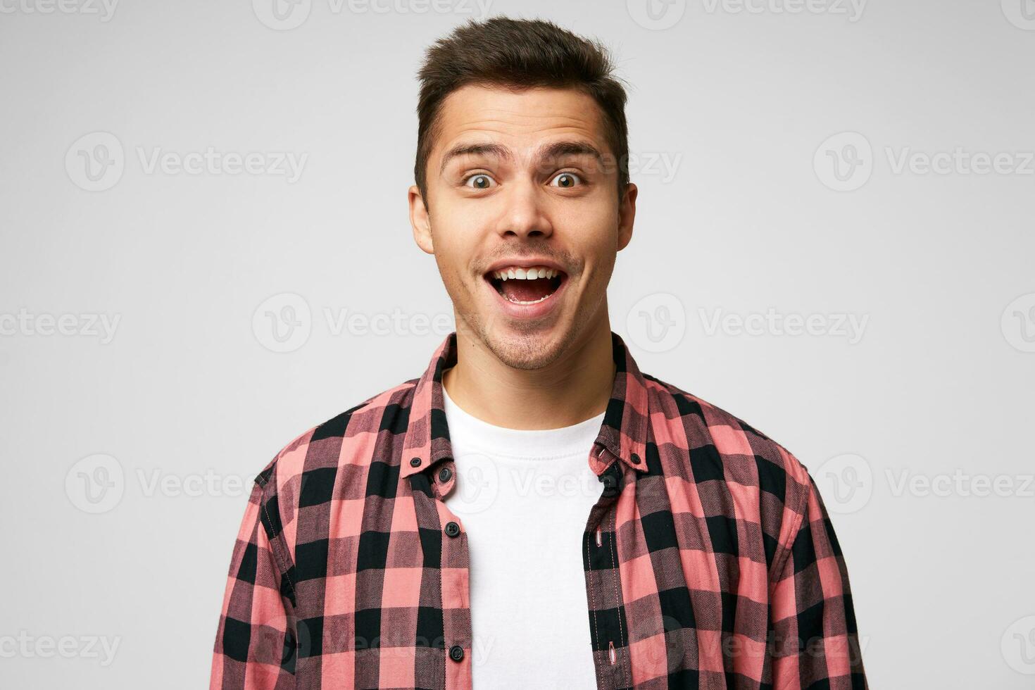 Portrait of a man by good fortune, luckily gets a prize. Male receives great offer, hears some incredible news, isolated over white background. photo