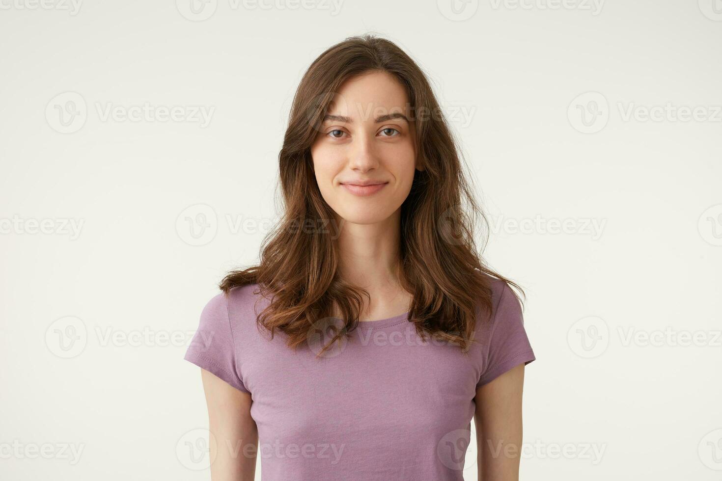 Sympathetic nice beautiful dark hair young girl confidently friendly pleasantly looking camera, wears violet t-shirt,isolated on a white background in studio. photo