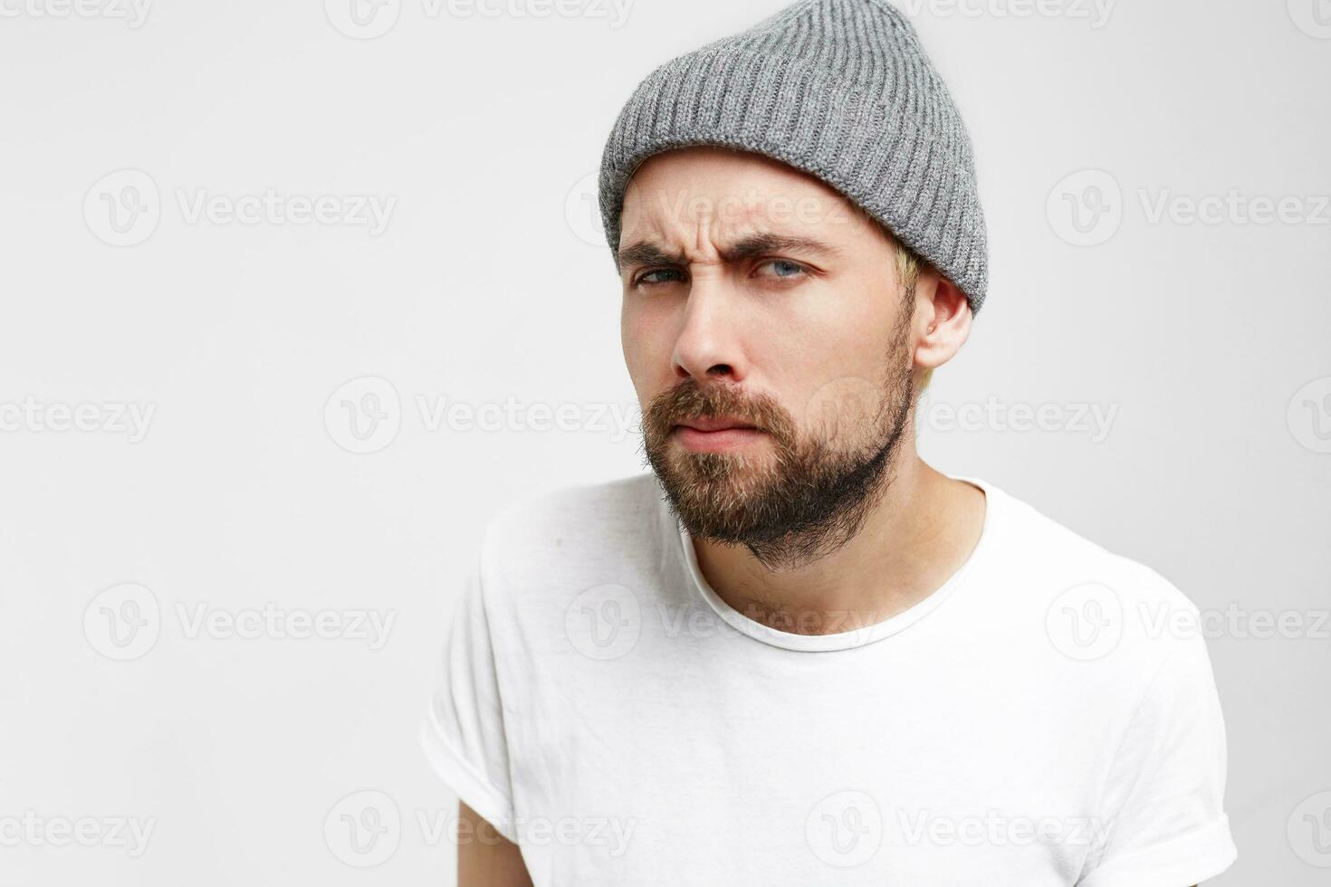 Man standing and waiting in front of door, see-through the peephole of door, eyes narrowed, shrill, meticulously, waiting until open, the neighbor came complaining about the noise, white background photo