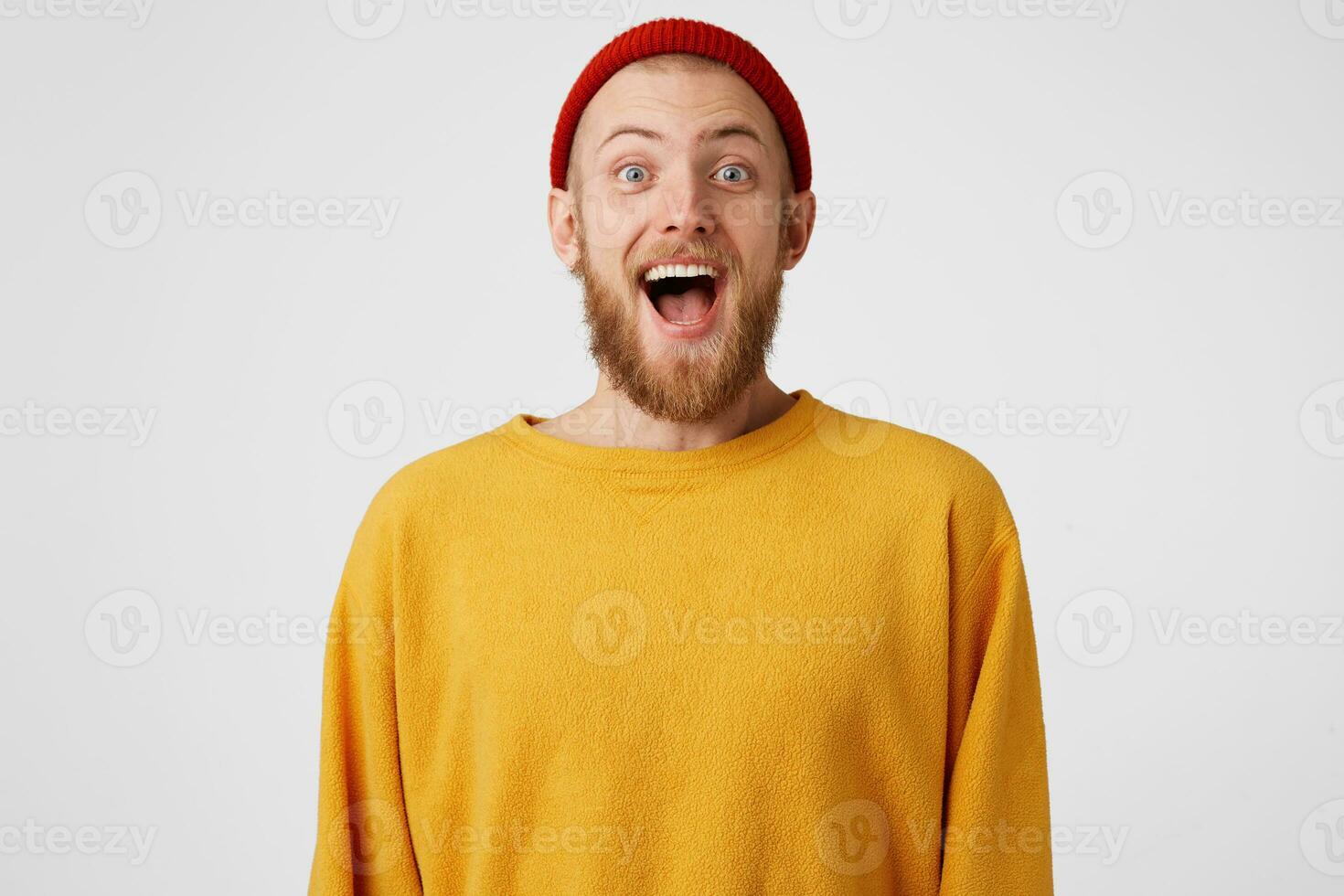 Happy guy is ready to jump from happiness. Bearded man with blue eyes overwhelmed with positive emotions, pleasantly surprised, reached results, won or gained success photo