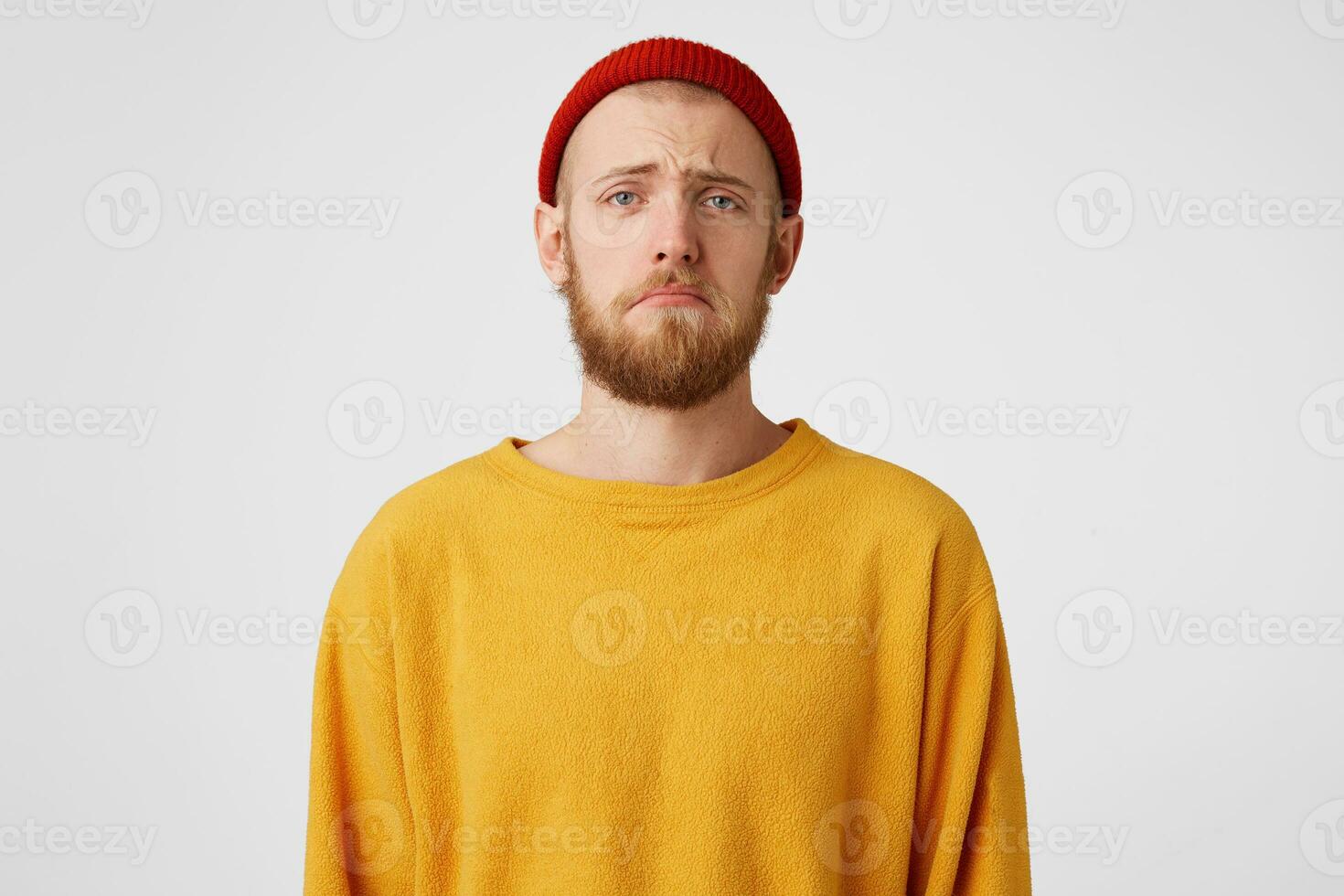 Portrait of one sad bearded man looking upset because of the girlfriend, in a bad mood, ready to cry, with hopeless facial expresion, over white wall photo