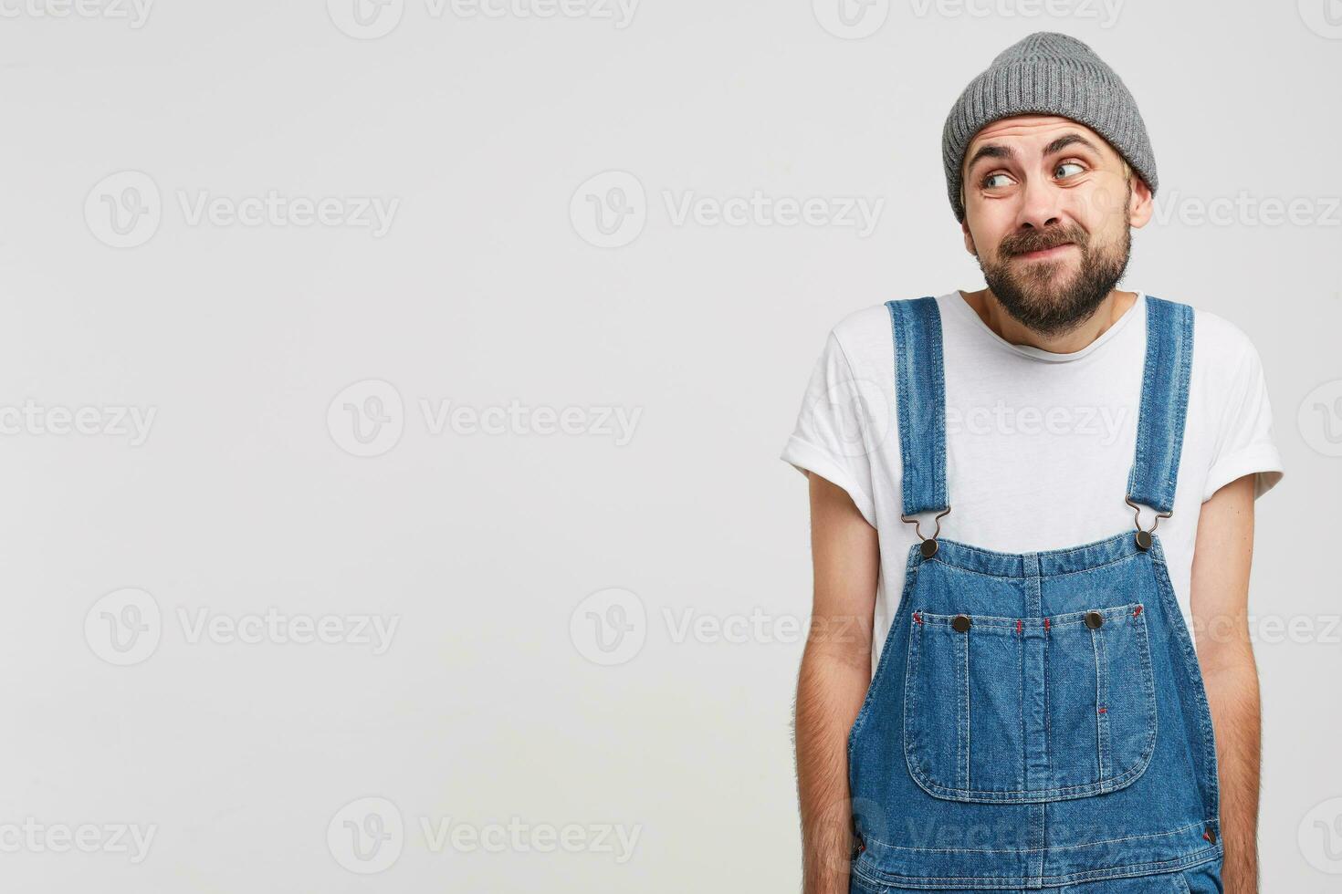 Man looks aside on a blank copy space, stands with a guilty apologetic expression, pretends that he regrets that it happened. Admits his fault, but does not know how to change everything photo