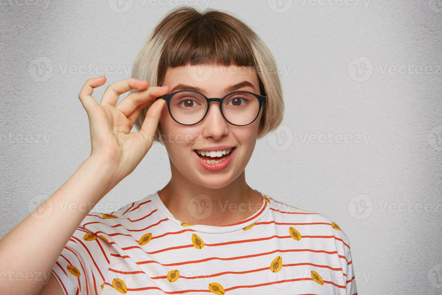 a woman wearing glasses and a striped shirt photo