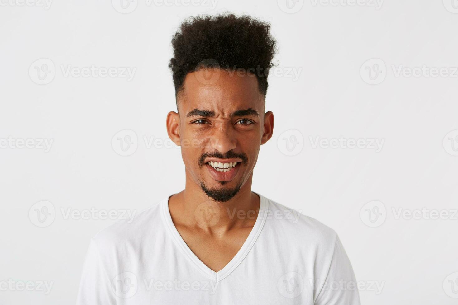 Closeup of angry african american young man with afro hairstyle wears t shirt photo