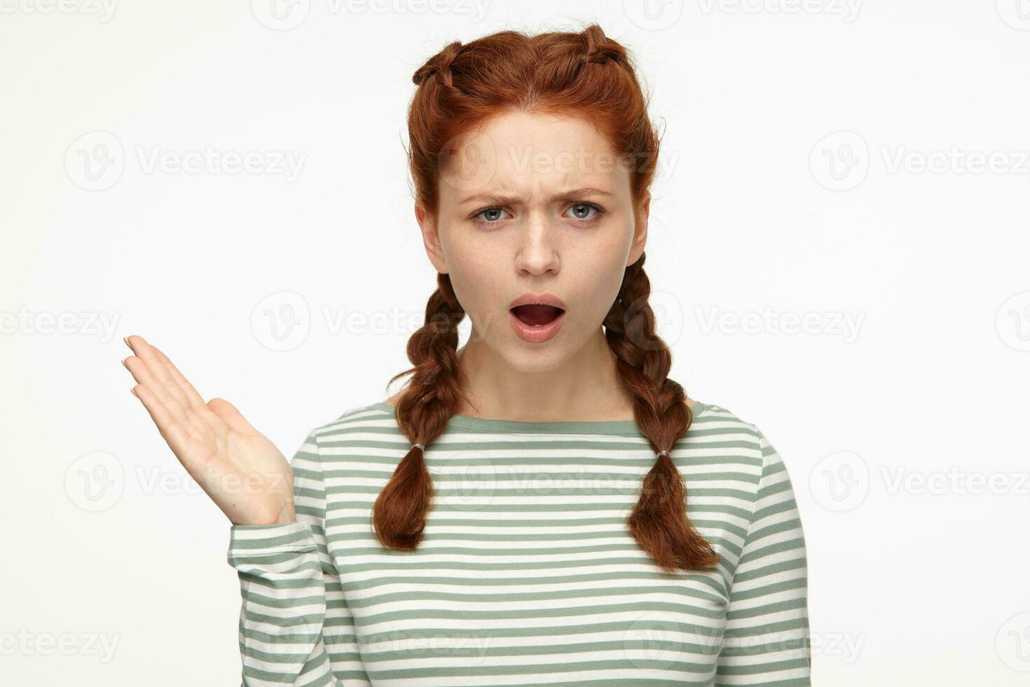 portrait of young ginger female standing over white studio background raised her hand with angry, mad facial expression photo