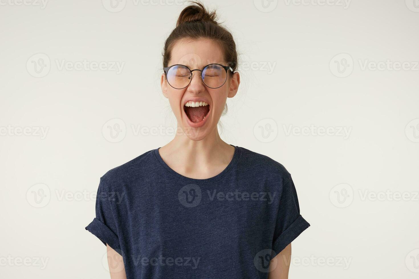 Screaming is one of the best way to get out negative emotions and take off the tense. Girl with closed eyes shouts loudly photo