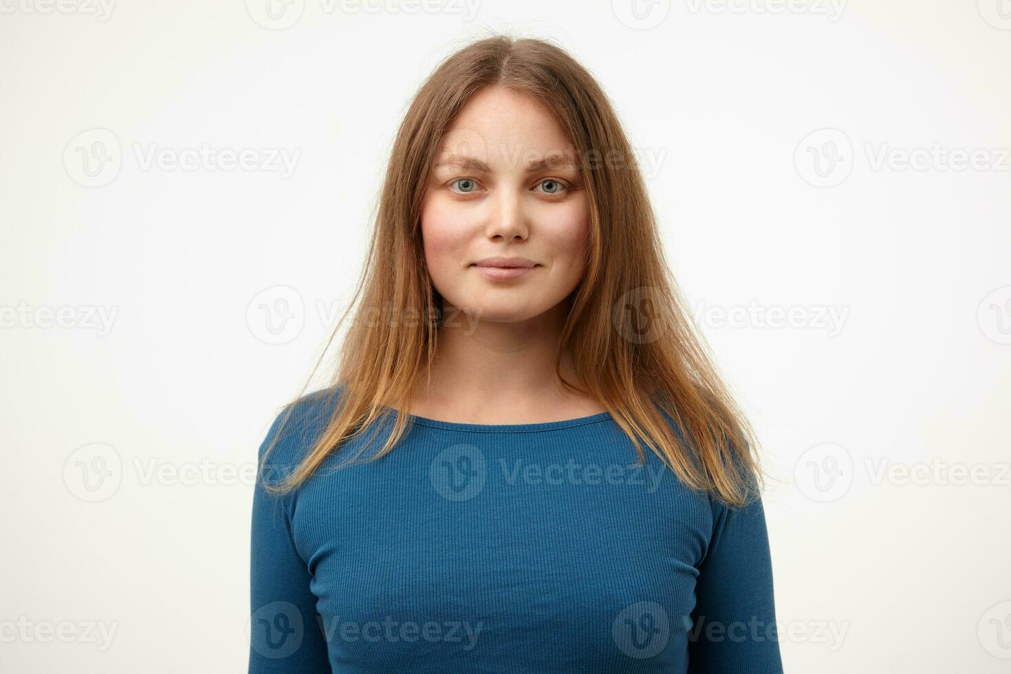 Portrait of attractive young white-headed female with natural makeup smiling gently while looking positively at camera, isolated over white background photo