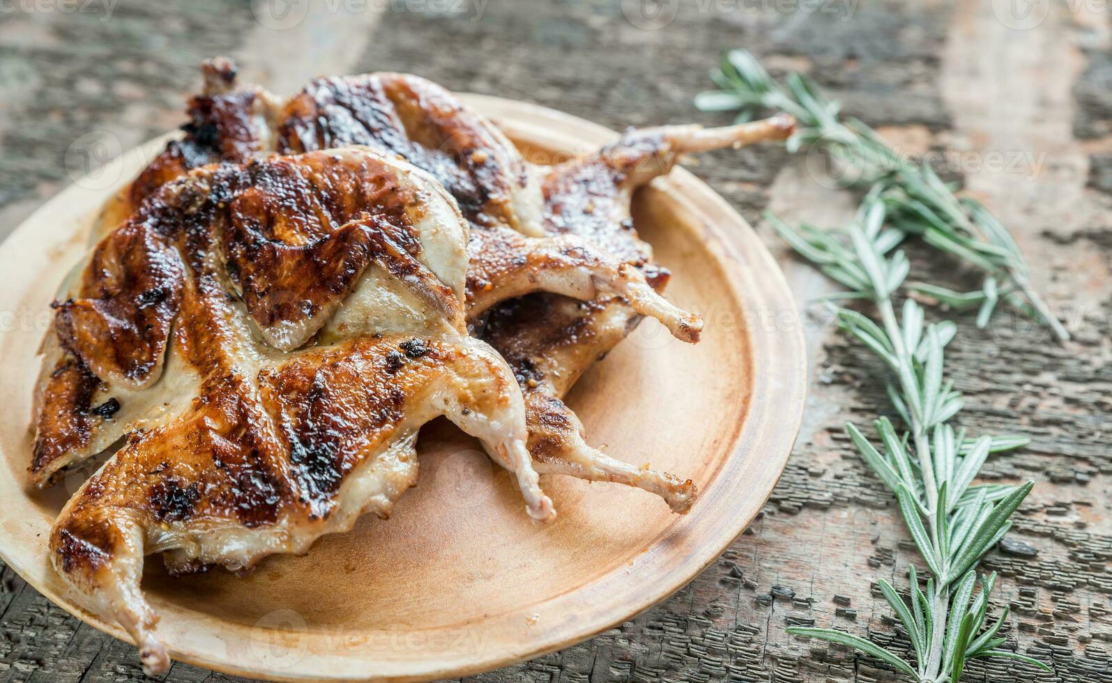 Grilled quails closeup photo