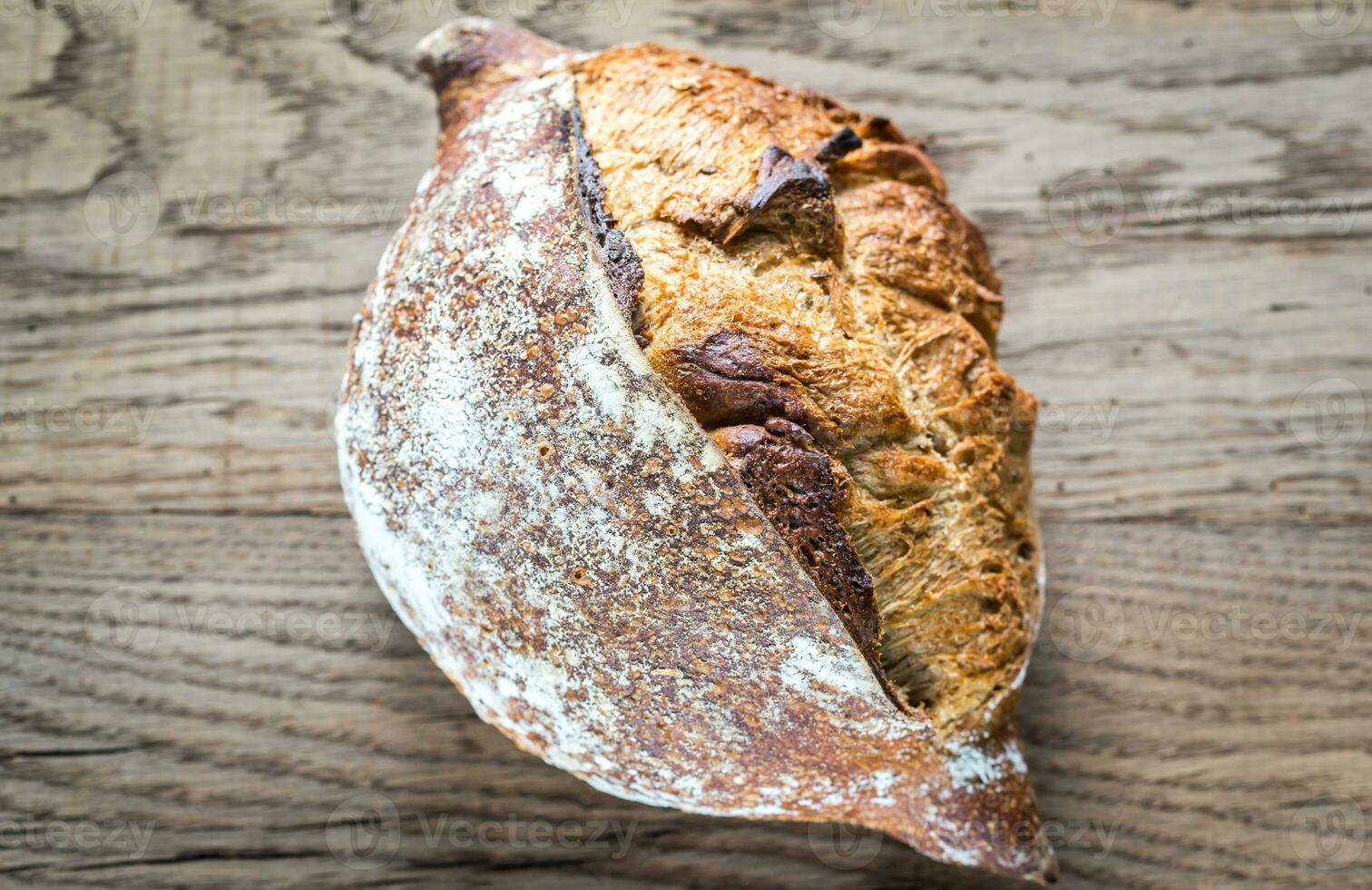 Wholegrain bread on the wooden background photo