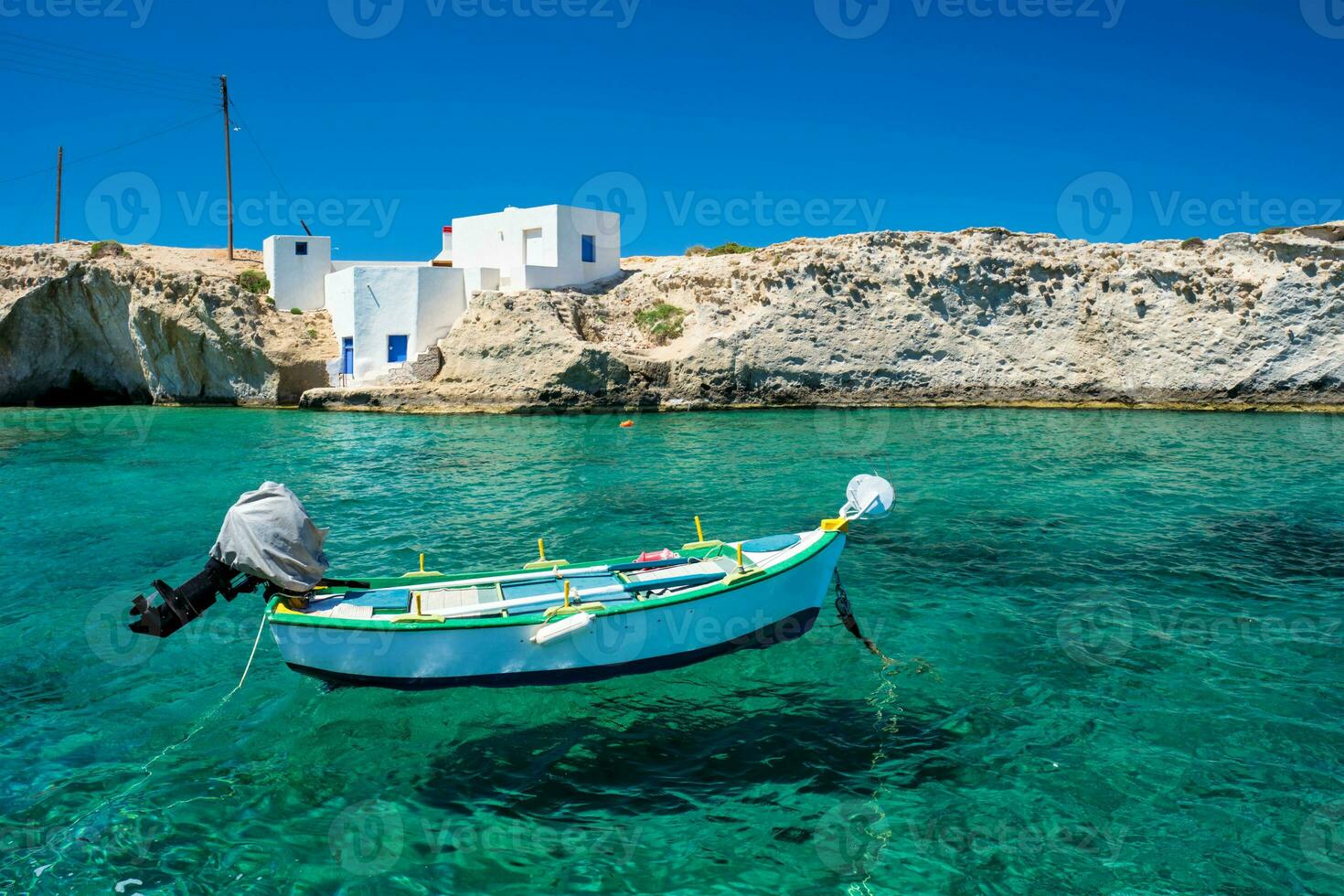 Crystal clear blue water at Mitakas village beach, Milos island, Greece. photo