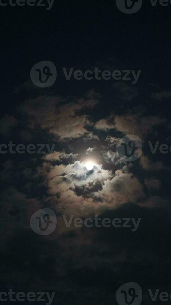 Beautiful magic blue night sky with clouds and full moon photo