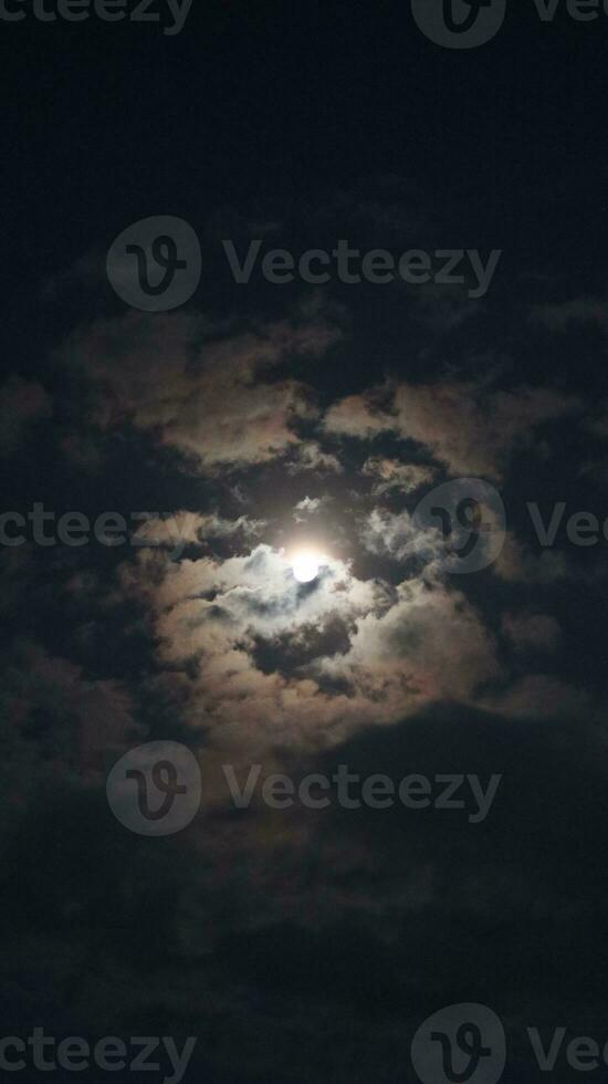 Beautiful magic blue night sky with clouds and full moon photo