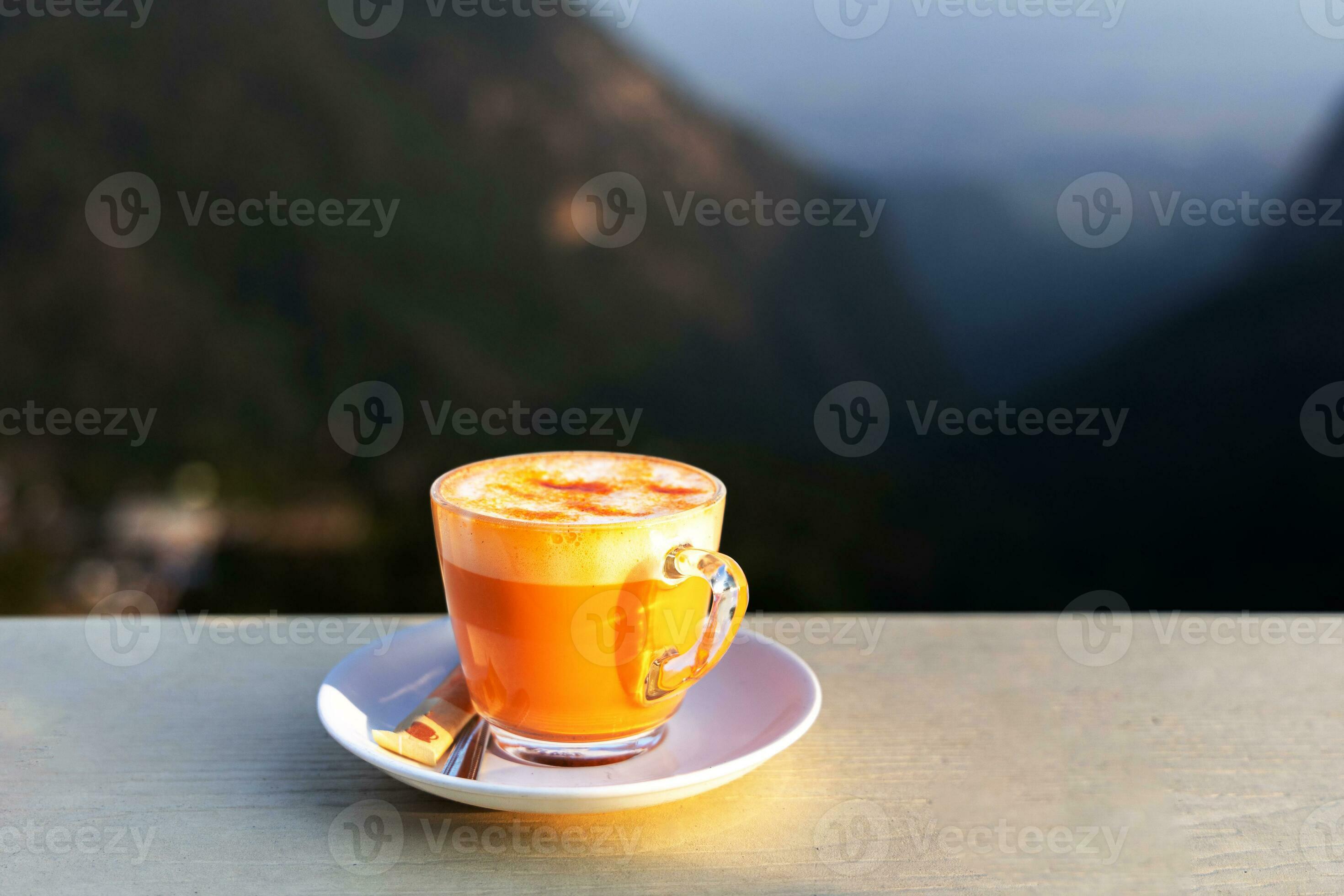 Hot Thai tea with milk foam in a glass Thailand's famous drink, Thai