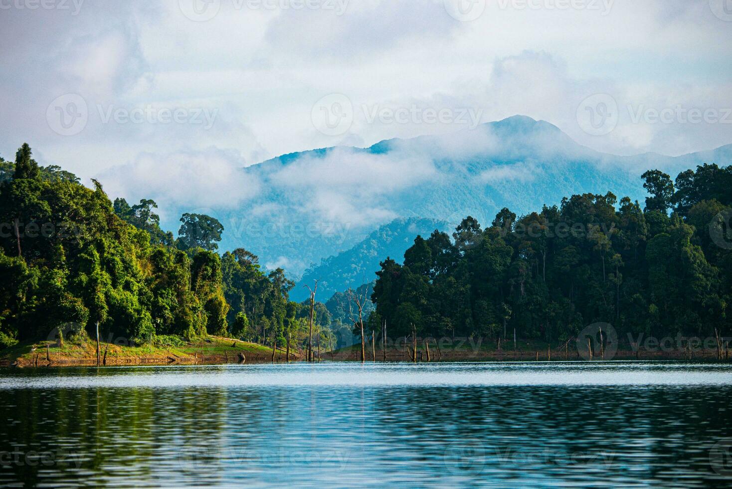 Khao Sok National Park, Surat Thani, Landscape Mountains with longtail boat for travelers, Cheow Lan lake, Ratchaphapha dam, Travel nature in Thailand, Asia summer vacation travel trip. photo