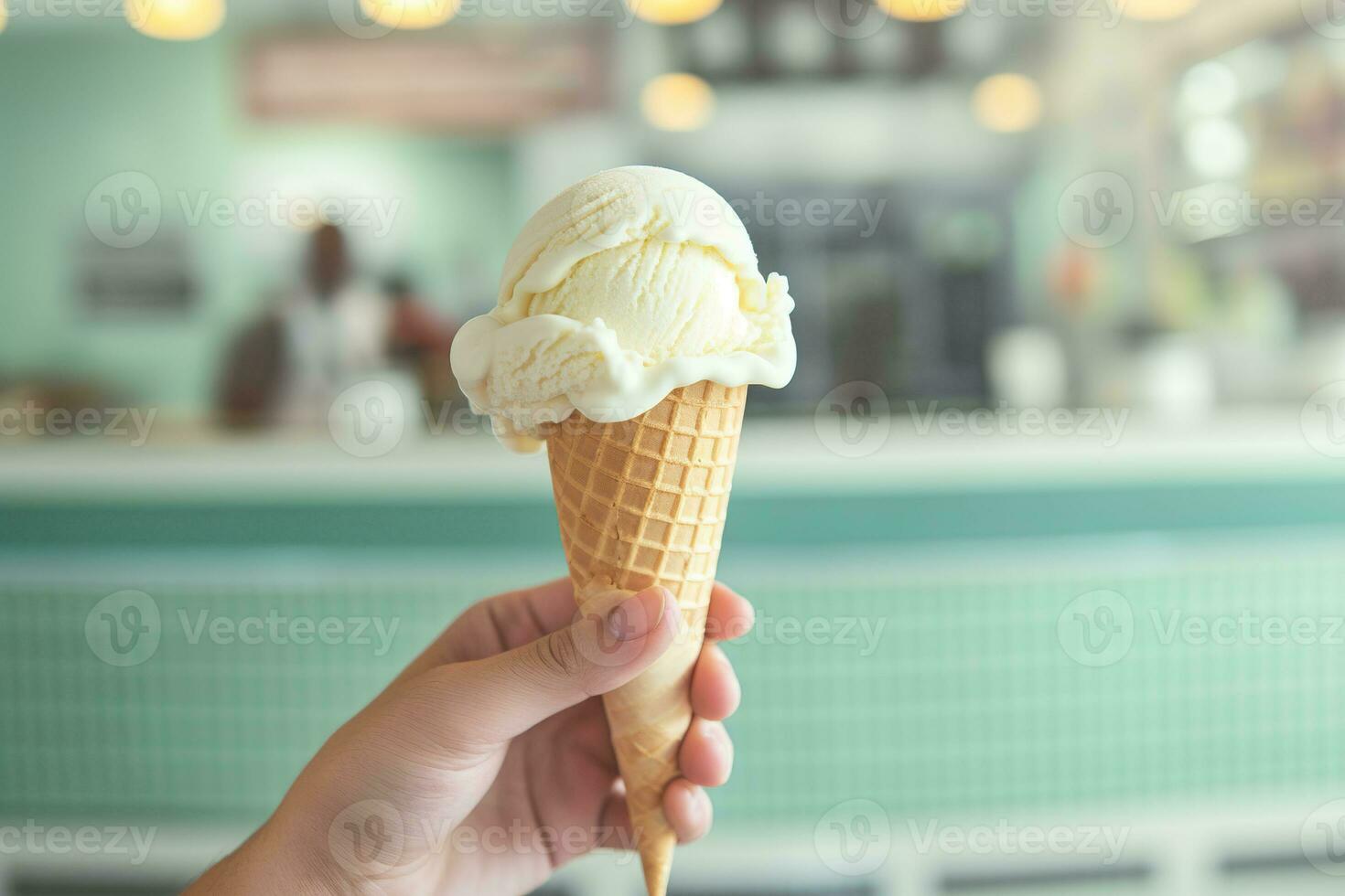 AI generated Hand holding vanilla ice cream scoop in a waffle cone against  parlor background. Generative AI. photo