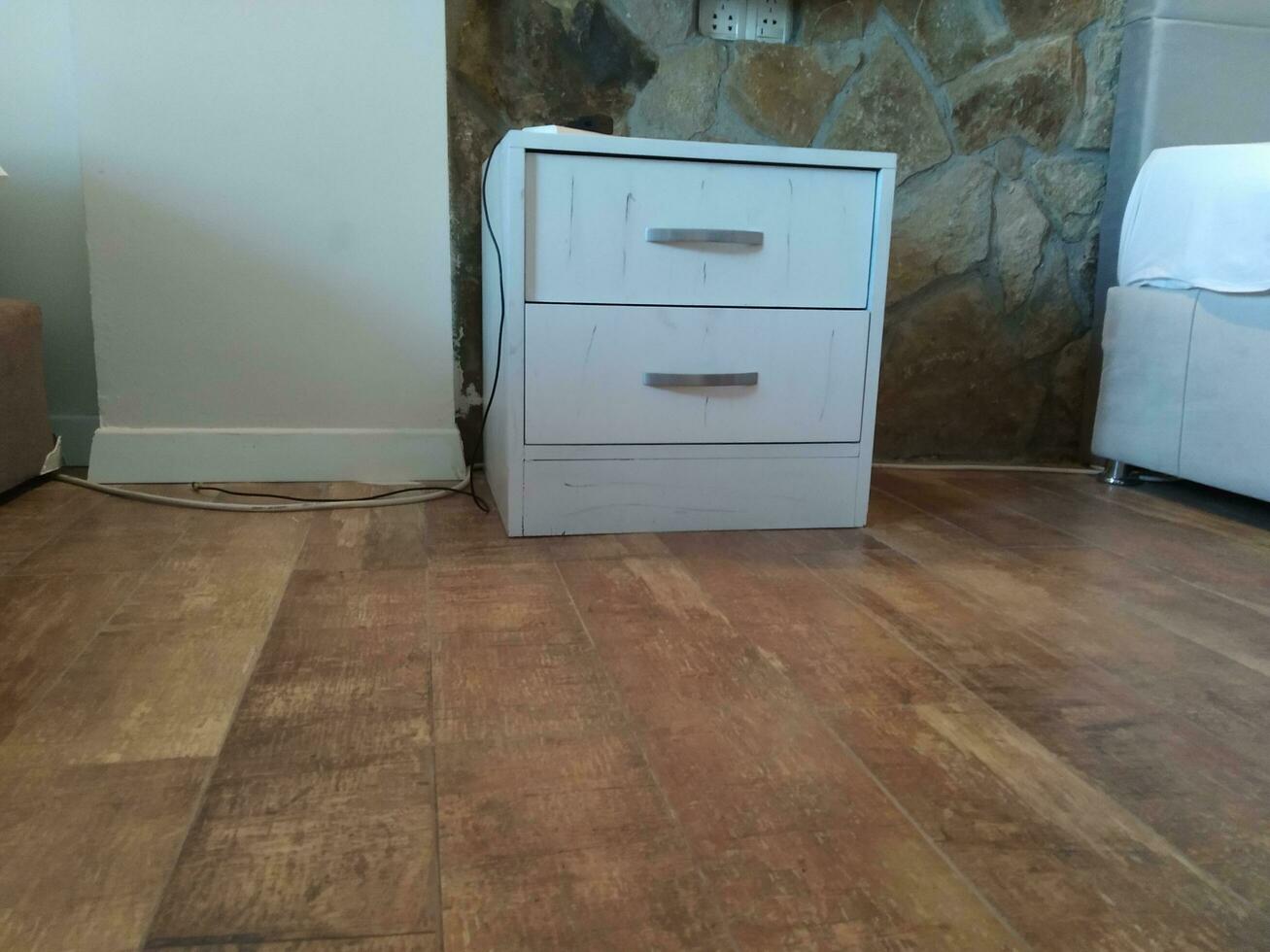 white chest of drawers on the floor in the interior of the room photo