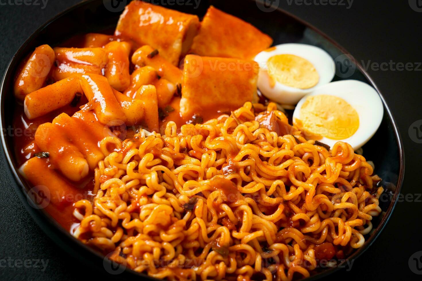 Korean instant noodles with Korean rice cake and fish cake and boiled egg photo