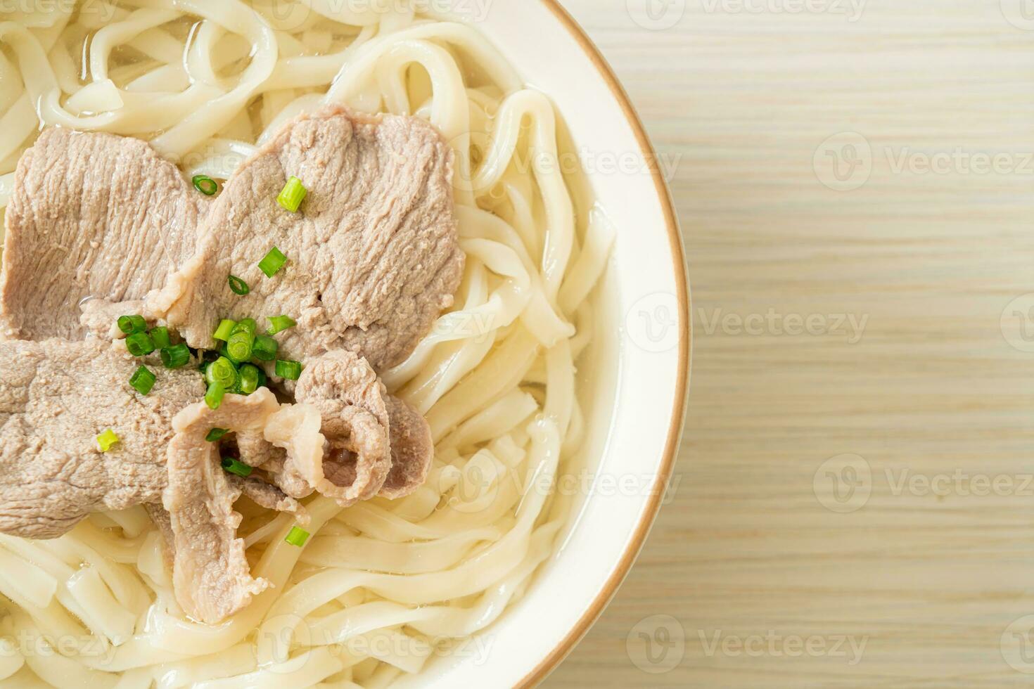 udon noodles with pork in clear soup photo