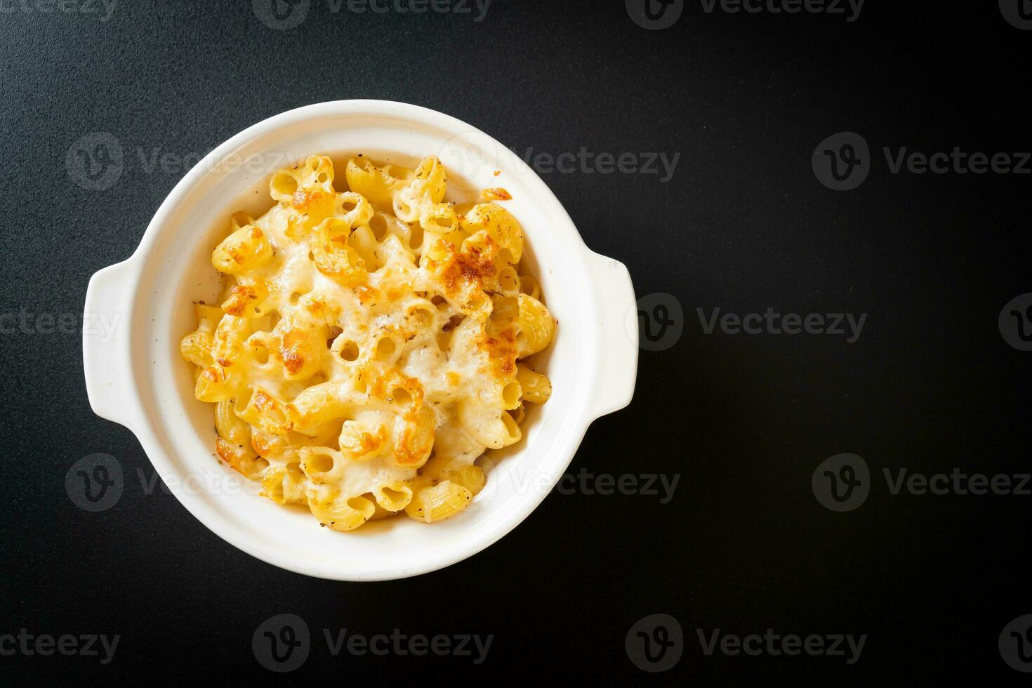 American mac and cheese, macaroni pasta in cheesy sauce photo