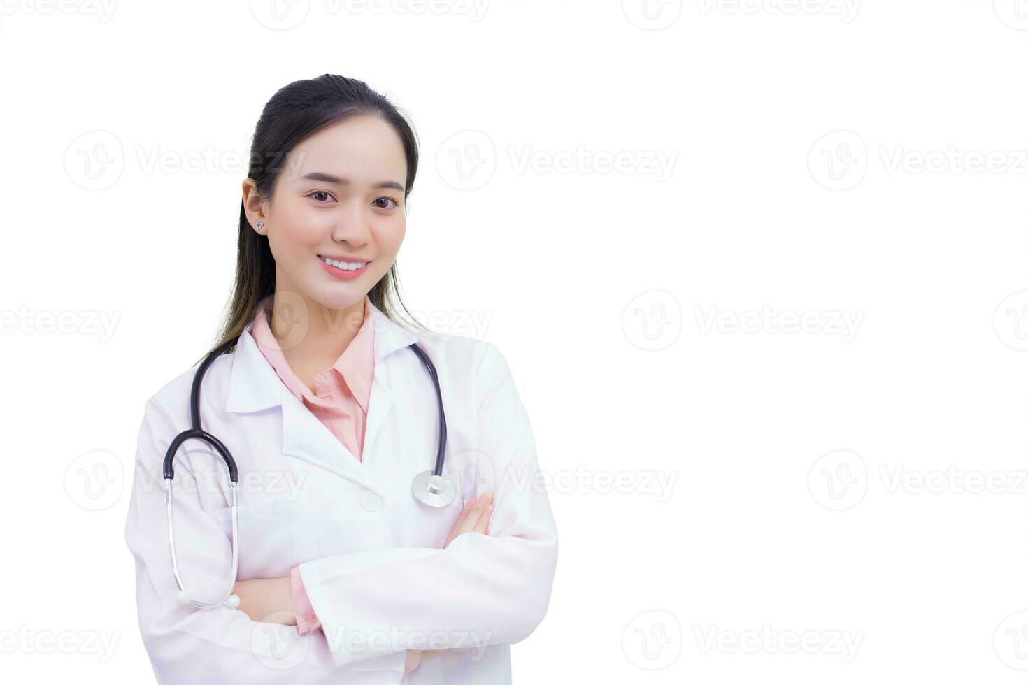Young professional Asian woman doctor standing with arms crossed confident and smile in hospital wearing white robe and stethoscope while isolated on white background. photo