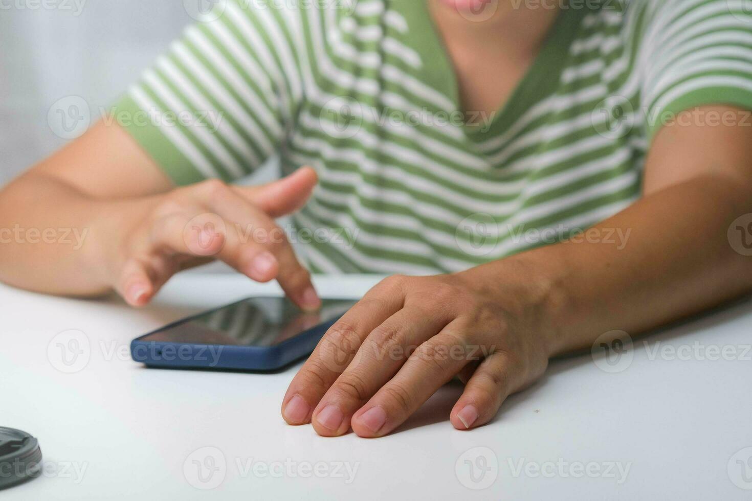 Pointing finger at mobile phone screen close up. Close-up of beautiful asian woman holding, using and looking at smartphone. photo