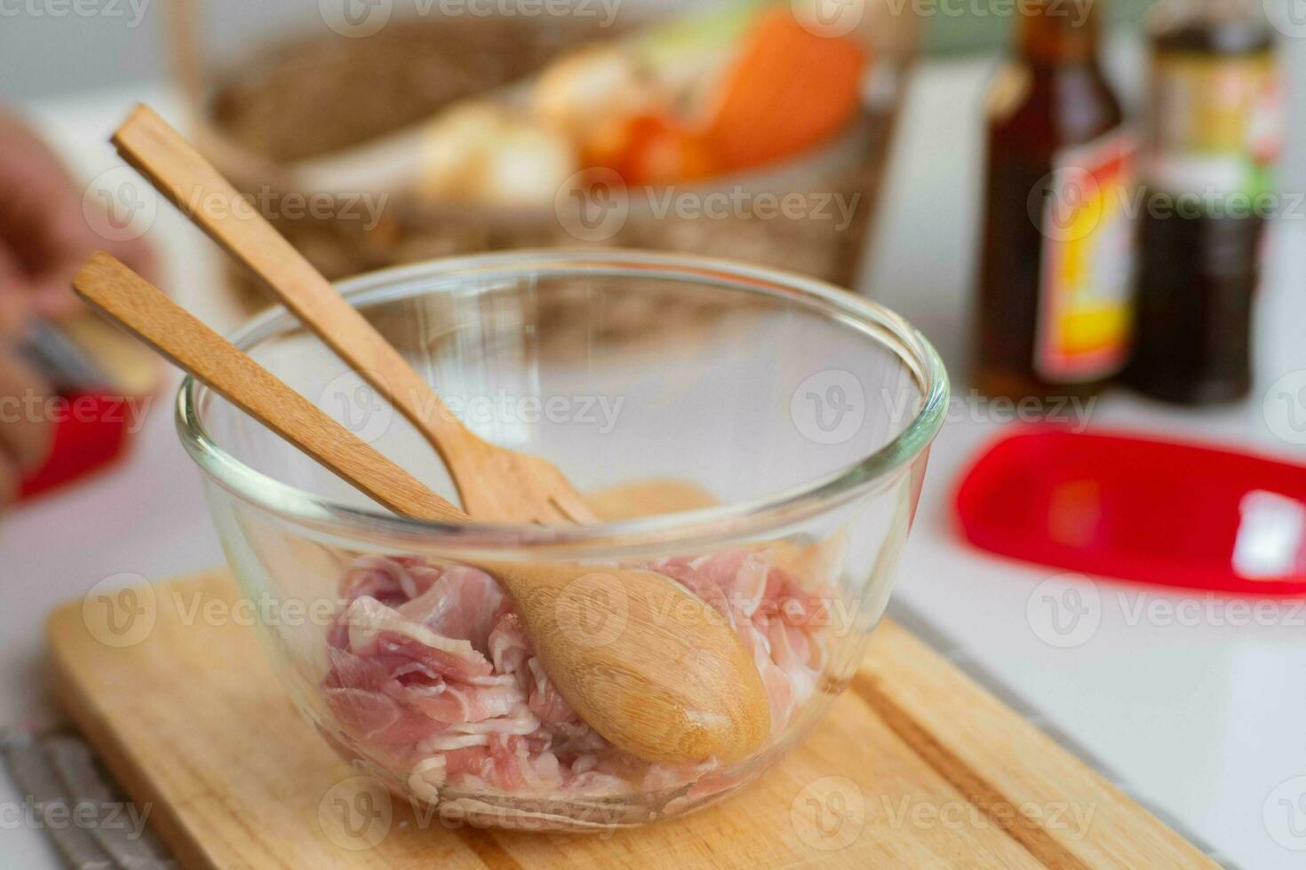 Step-by-step procedures to marinate pork for easy Korean cooking, add chopped onions and Japanese bunching onion, sesame oil, soy sauce, Korean gochujang and mix well. Korean homemade food for lunch photo