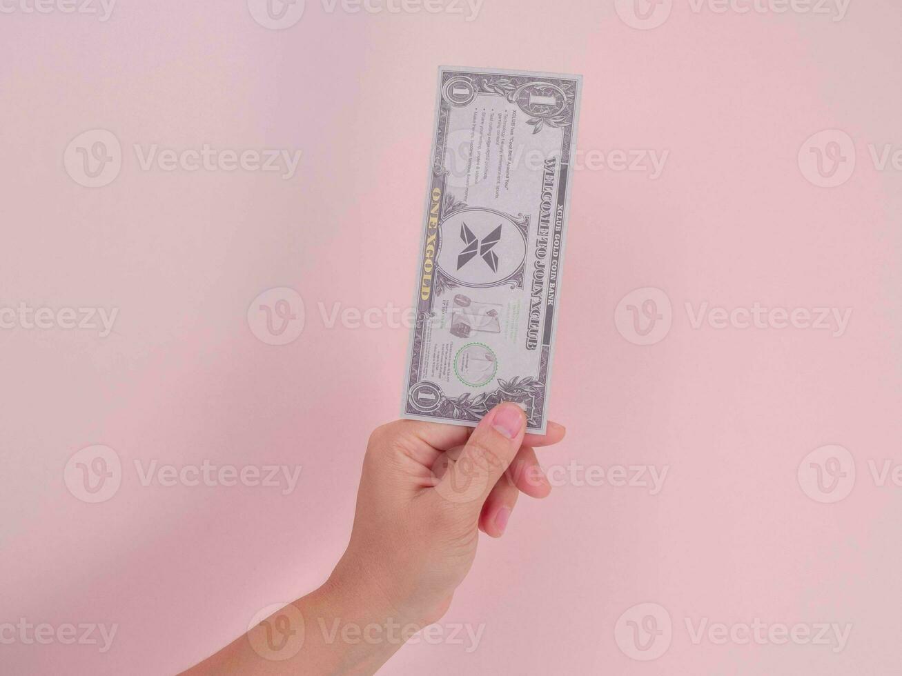 Hand holding one dollar bill isolated on pink background. Money Financial and Payment Concept. photo