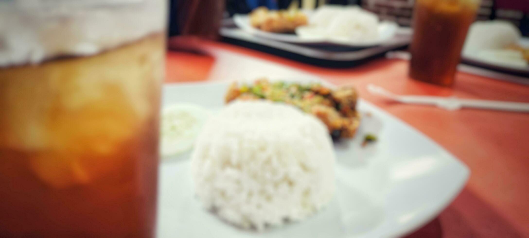 Blurred portrait of Indonesian food Geprek chicken, crispy fried chicken with spicy chili sauce, one of the popular street foods in Indonesia photo