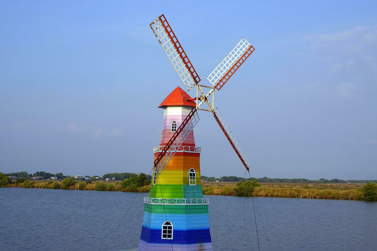 A rainbow windmill on the canal photo