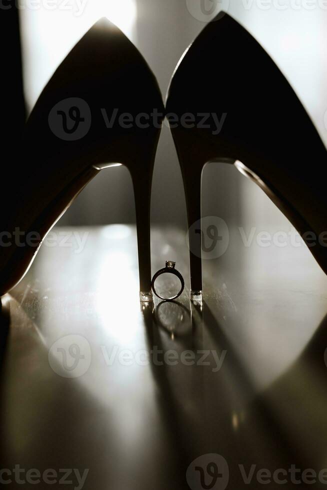 wedding ring white shoes of the bride in soft light photo