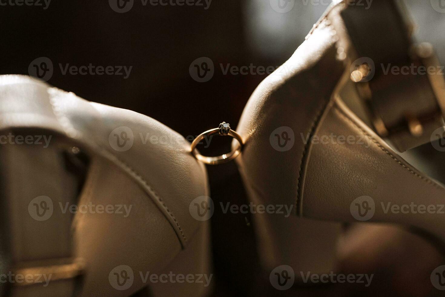 elegant women's ring on a dark background is set between women's shoes photo