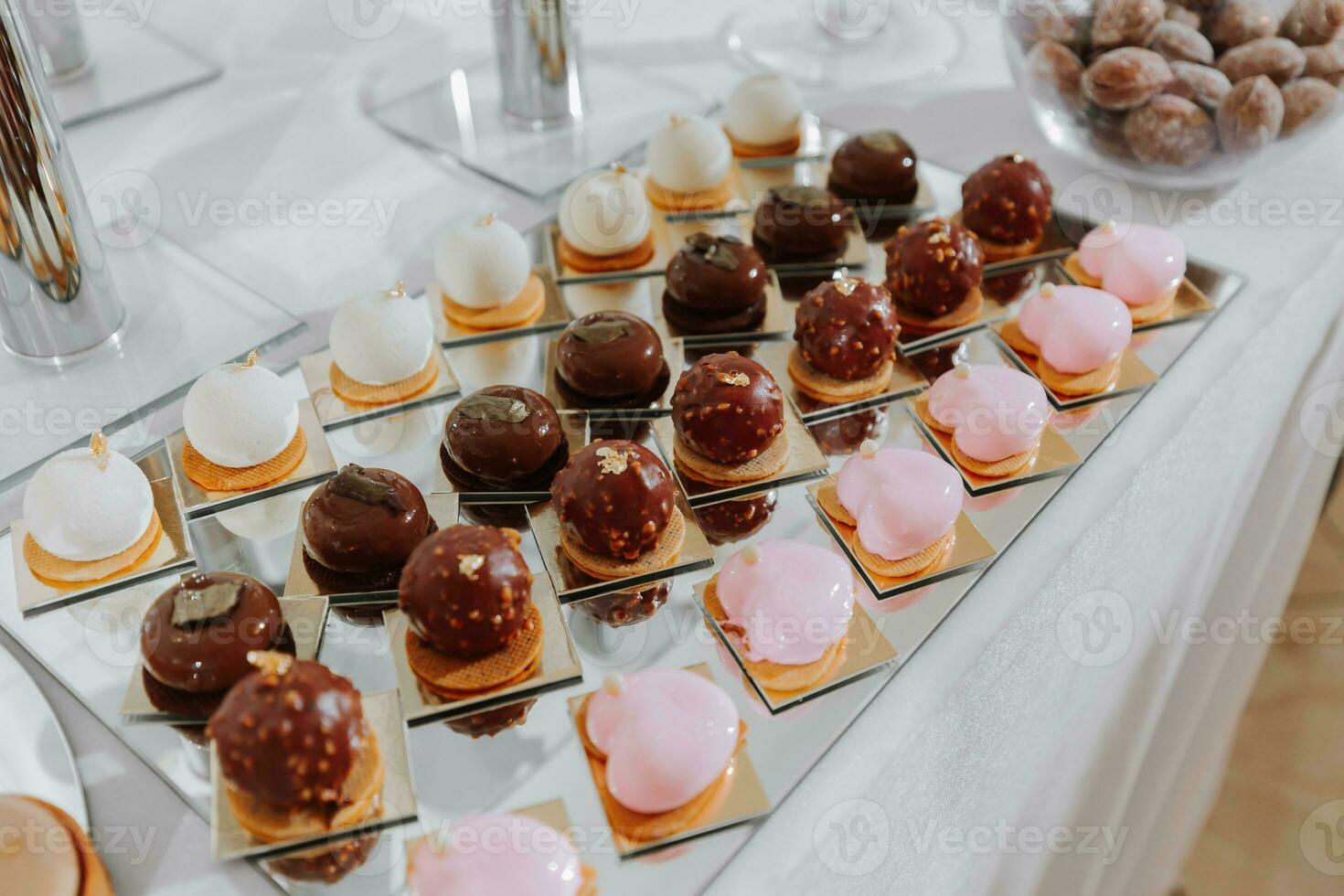 Festive dessert table with sweets. Wedding candy bar, various cakes, chocolates on stands. photo