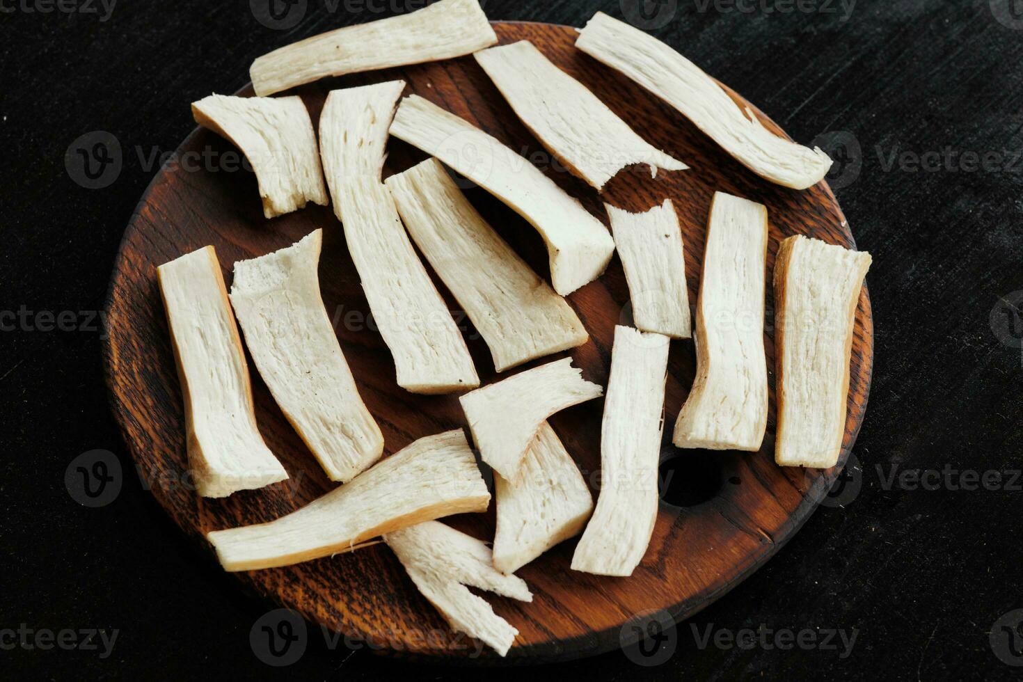 slices of boletus mushroom root laid out on a wooden stand, healthy eating concept photo