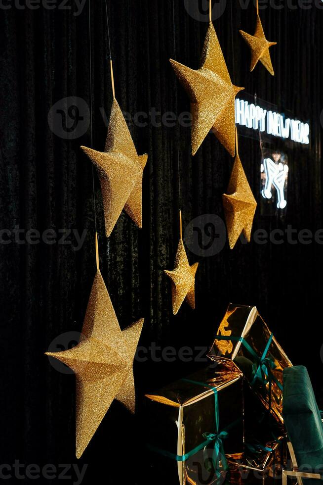 Golden stars on a dark background, new year concept photo