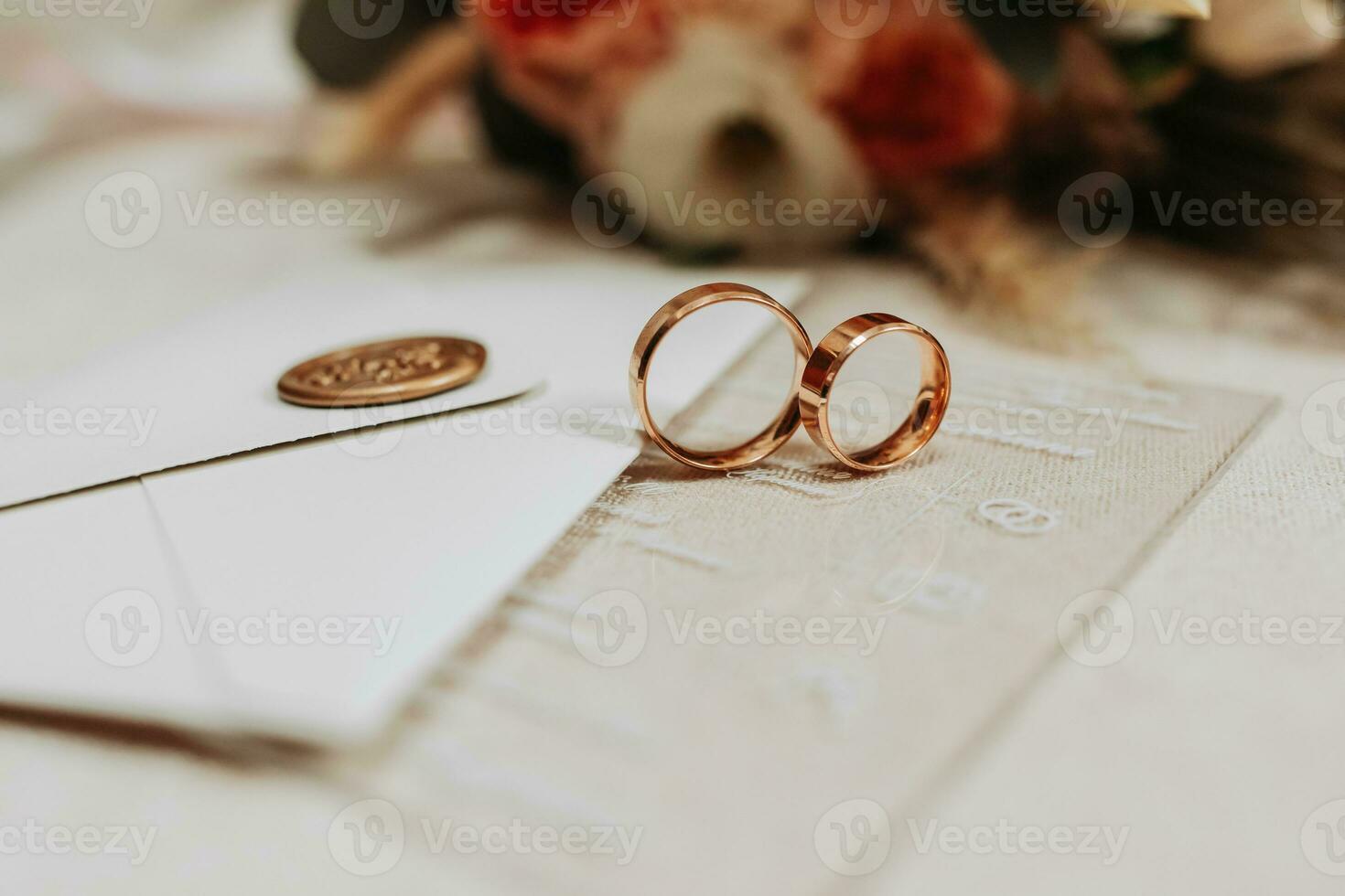 gold wedding rings near the envelope with wedding vows. Selective focus photo