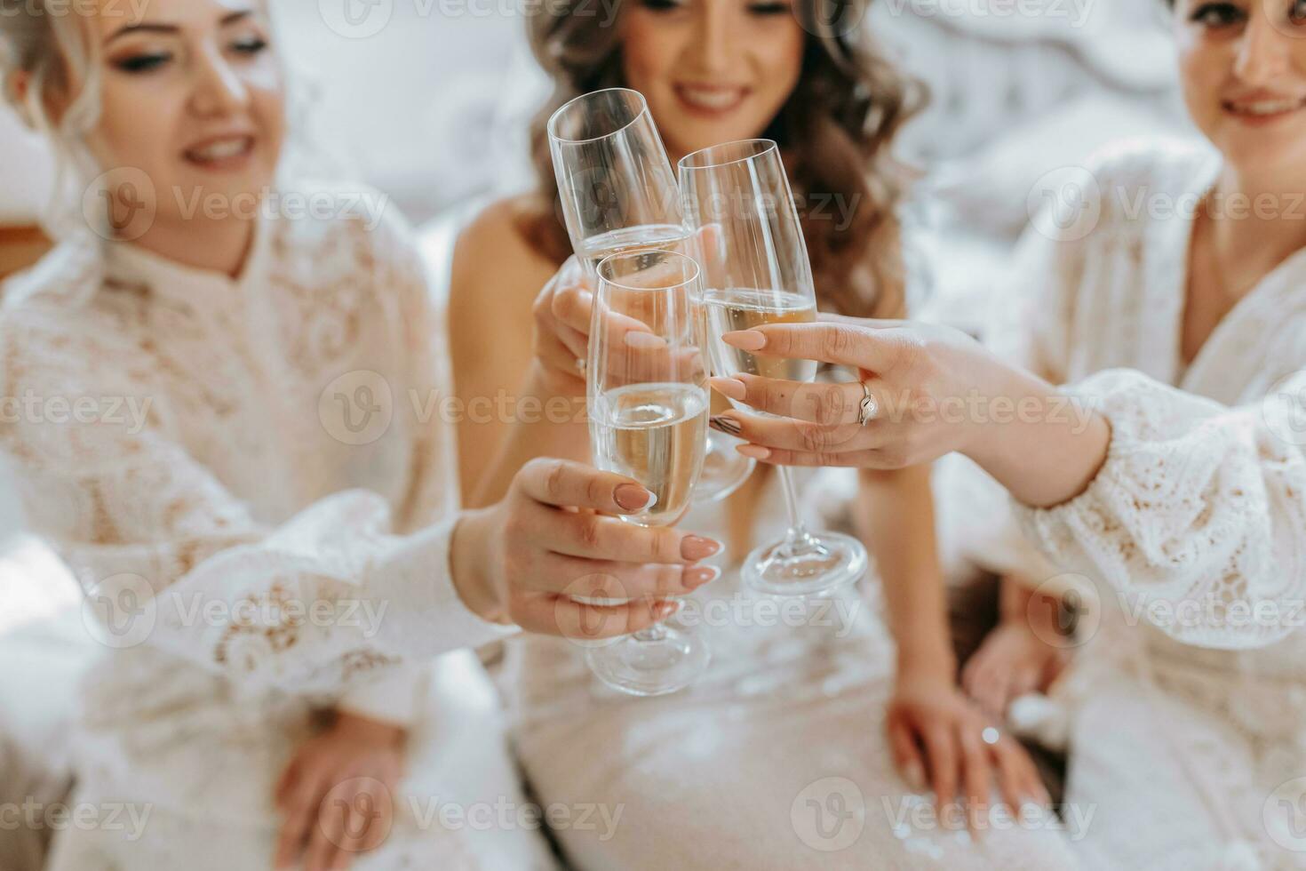 The bride and her girlfriends are celebrating their wedding day in the room. The girl the evening before the wedding. Glasses close-up photo