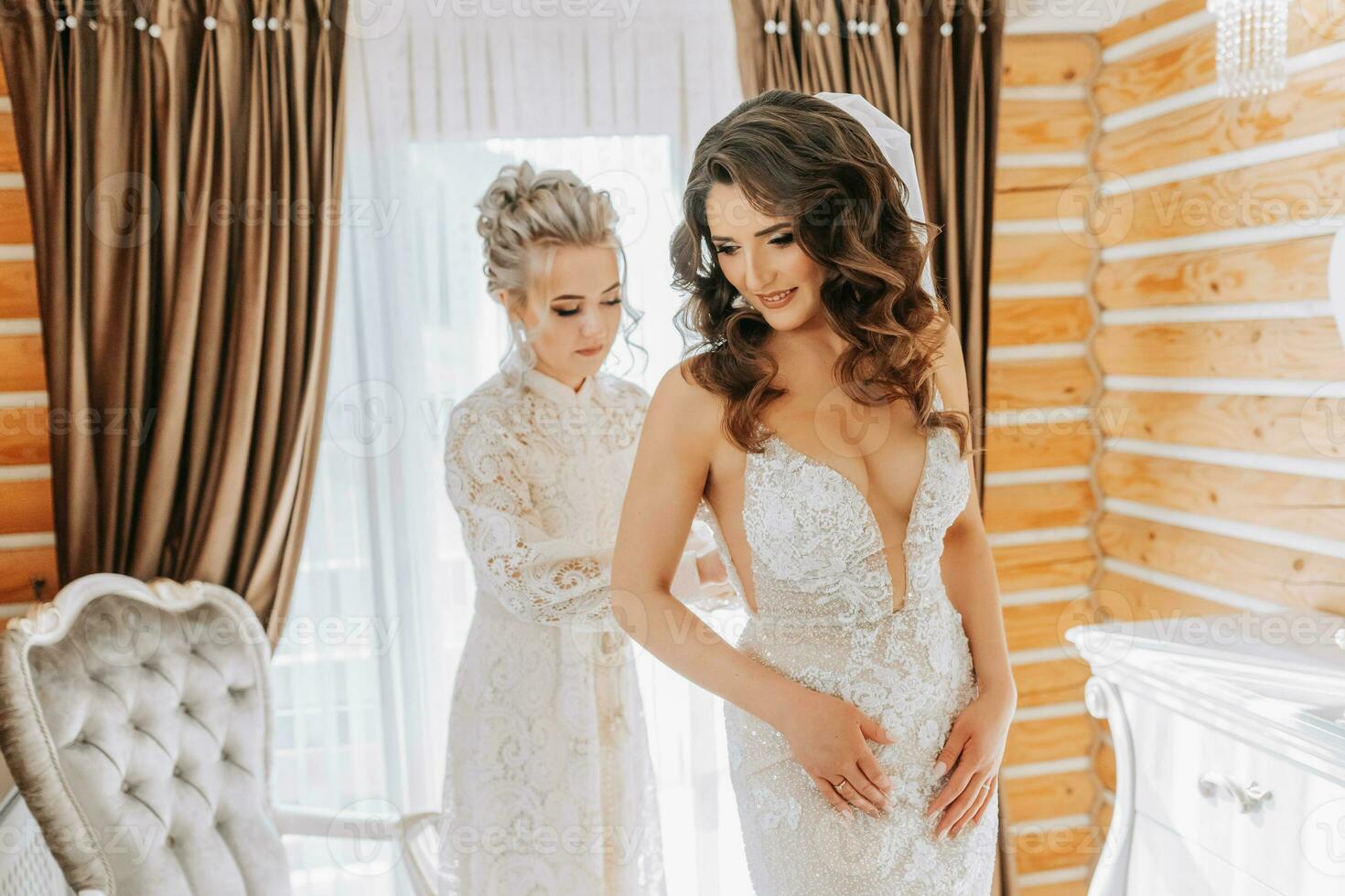 girlfriends help the bride prepare for the wedding. photo