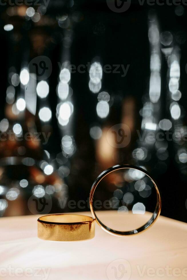 Two wedding rings in backlight with beautiful bokeh, close-up photo