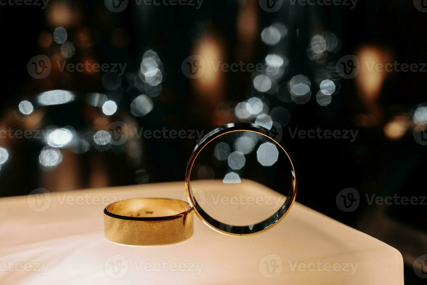 Two wedding rings in backlight with beautiful bokeh, close-up photo