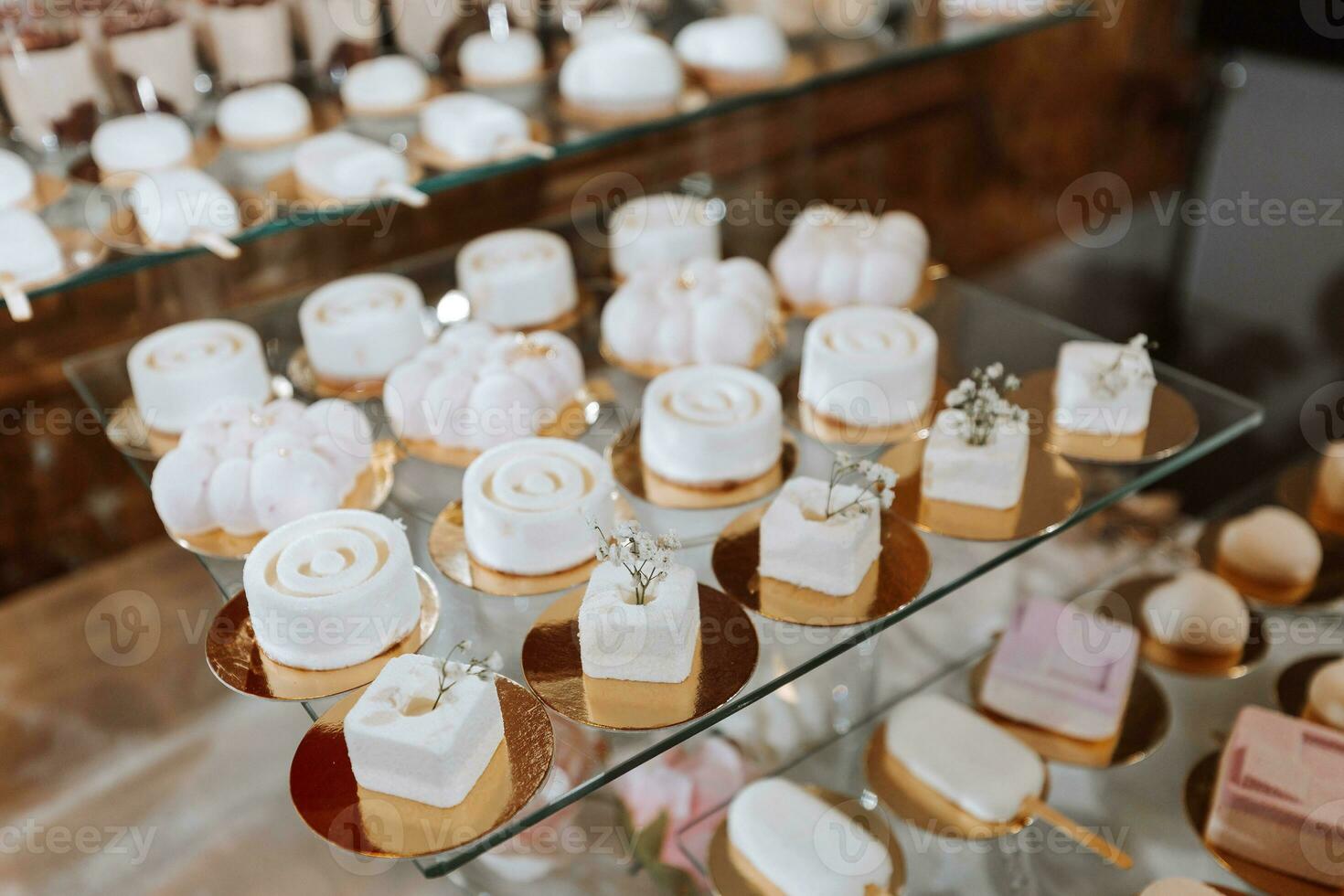 Festive dessert table with sweets. Wedding candy bar, various cakes, chocolates on stands. photo