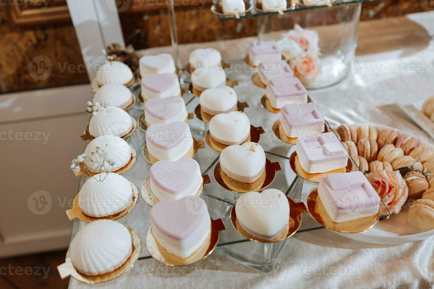 Festive dessert table with sweets. Wedding candy bar, various cakes, chocolates on stands. photo
