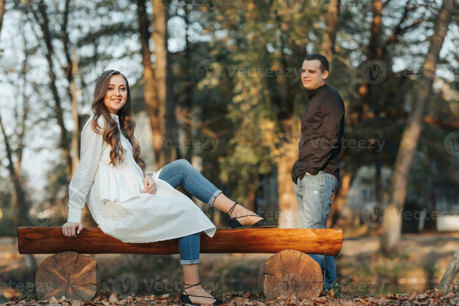 young happy pregnant woman relaxing and enjoying life in nature. The beauty of a woman during pregnancy. Autumn mood during pregnancy. Self improvement. photo