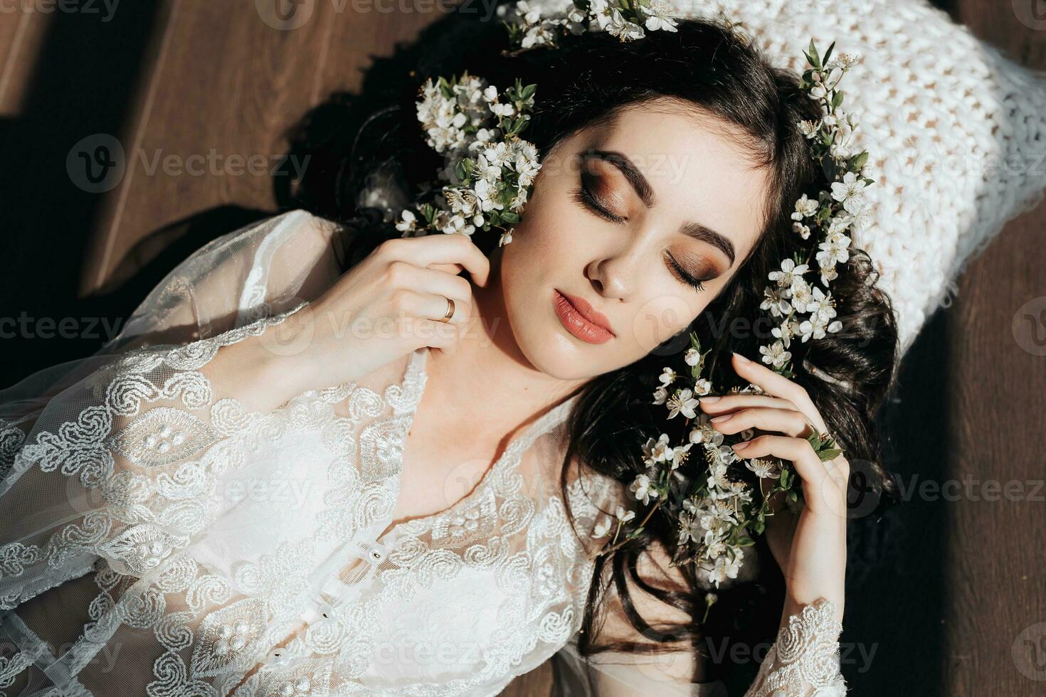 beautiful pregnant woman in a lace transparent dress lying on the floor in flowers. Concept of pregnancy, motherhood, preparation and waiting. The beauty of a woman during pregnancy photo