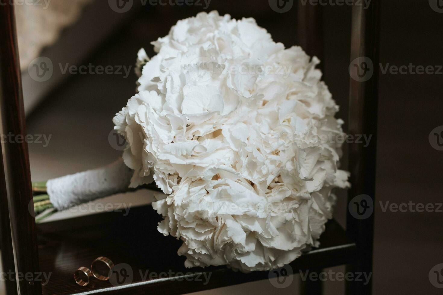 wedding bouquet of white hydrangea flowers on a wooden stand photo