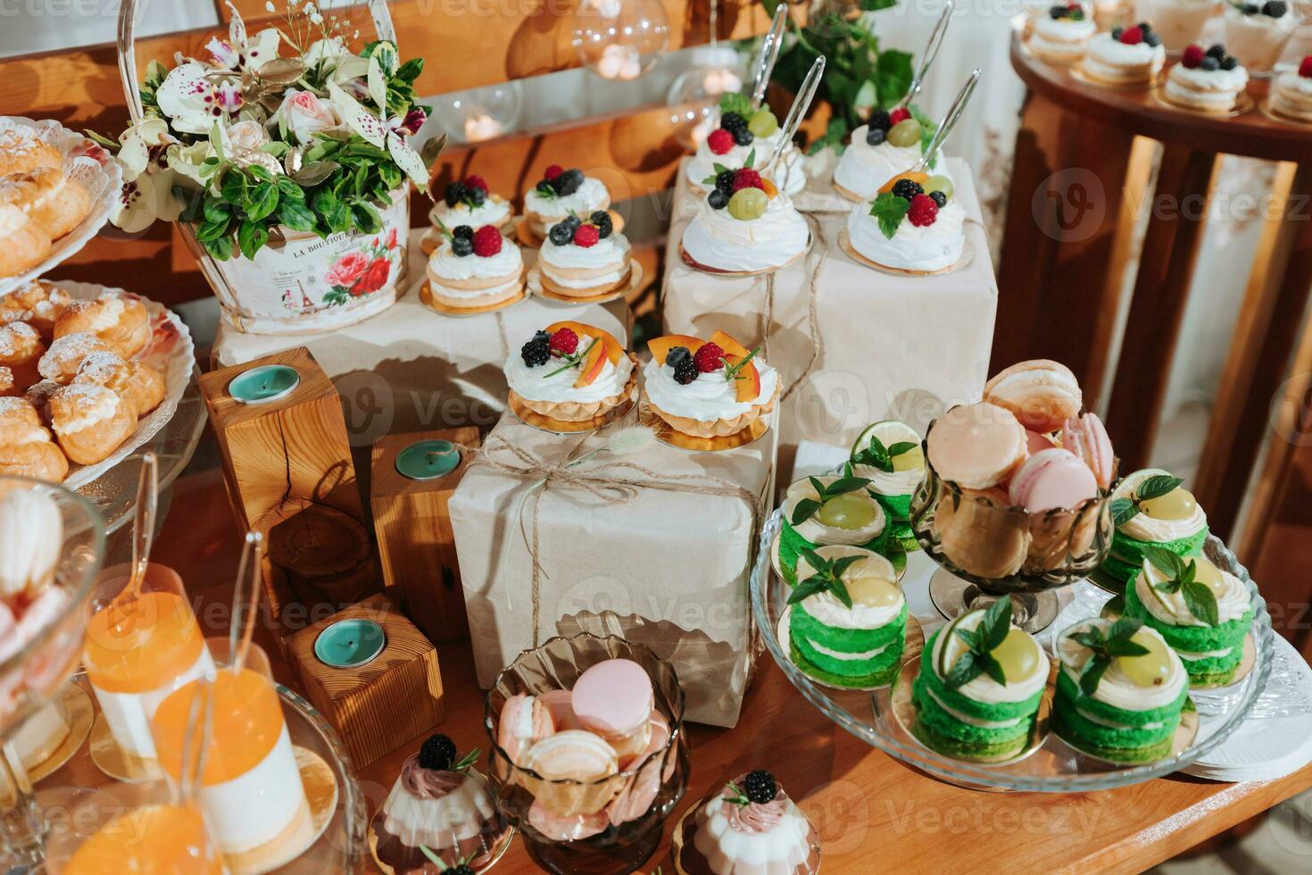 Festive dessert table with sweets. Wedding candy bar, various cakes, chocolates on stands. photo