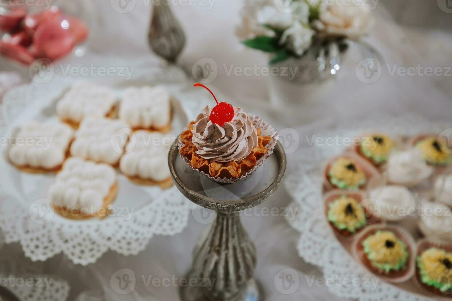 Festive dessert table with sweets. Wedding candy bar, various cakes, chocolates on stands. photo